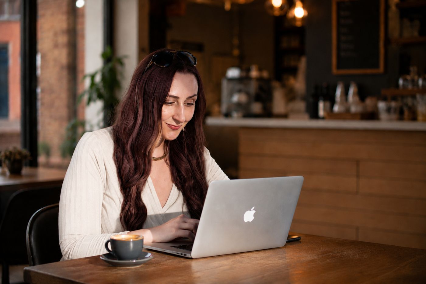 Katie working on a laptop in a cafe